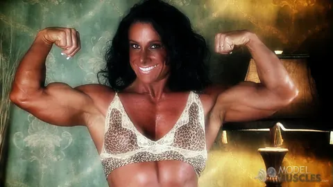 Debbie Bramwell: Brunette MILF Flexes Her Muscles and Shows Pierced Belly in the Gym – photo 19 of 21