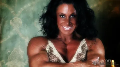 Debbie Bramwell: Brunette MILF Flexes Her Muscles and Shows Pierced Belly in the Gym – photo 15 of 21