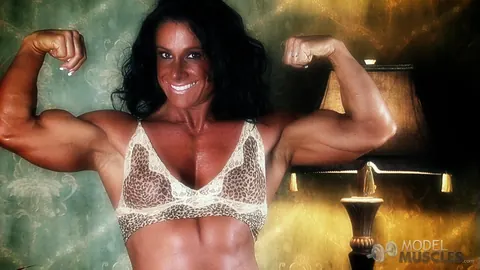 Debbie Bramwell: Brunette MILF Flexes Her Muscles and Shows Pierced Belly in the Gym – photo 16 of 21