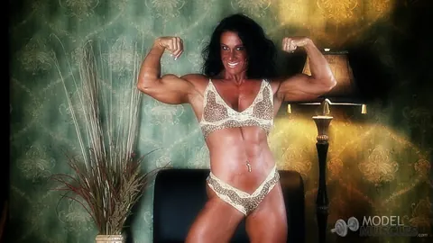Debbie Bramwell: Brunette MILF Flexes Her Muscles and Shows Pierced Belly in the Gym – photo 20 of 21
