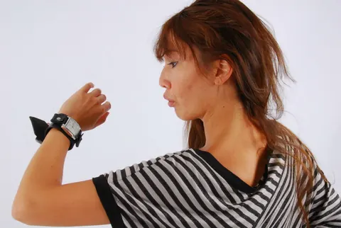 Asian Redhead Checks Her Watch While Posing in Shorts – photo 5 of 16