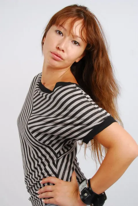 Asian Redhead Checks Her Watch While Posing in Shorts – photo 11 of 16