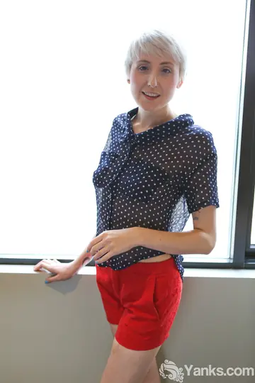 Short-Haired Blonde Strips Out of Her Shorts by the Window
