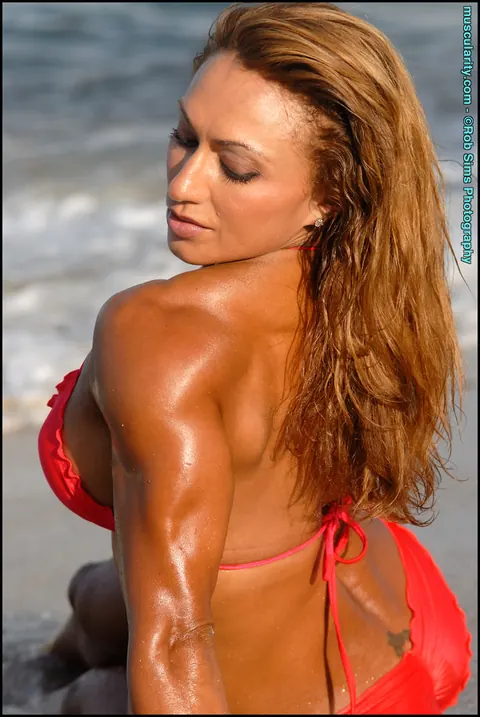 Karina Nascimento: Busty Blonde MILF Flexes and Strips Nude in a Red Bikini on the Beach – photo 6 of 15