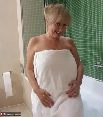 European Blonde MILF Spreads Her Pussy Lips in the Bathroom