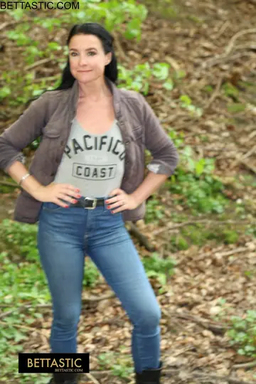 Brunette Poses Outdoors in Jeans and Turns Around