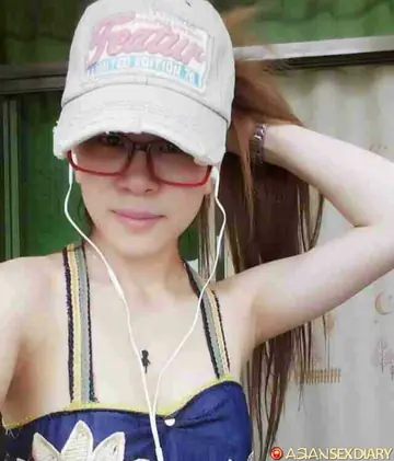 Asian Woman in Shorts and Glasses Takes a Selfie