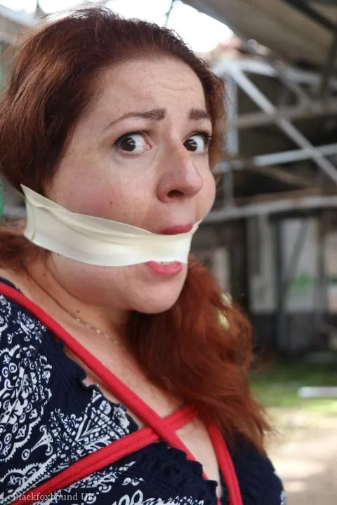 Curvy Redhead Bound and Gagged to a Post in a Warehouse – photo 12 of 16