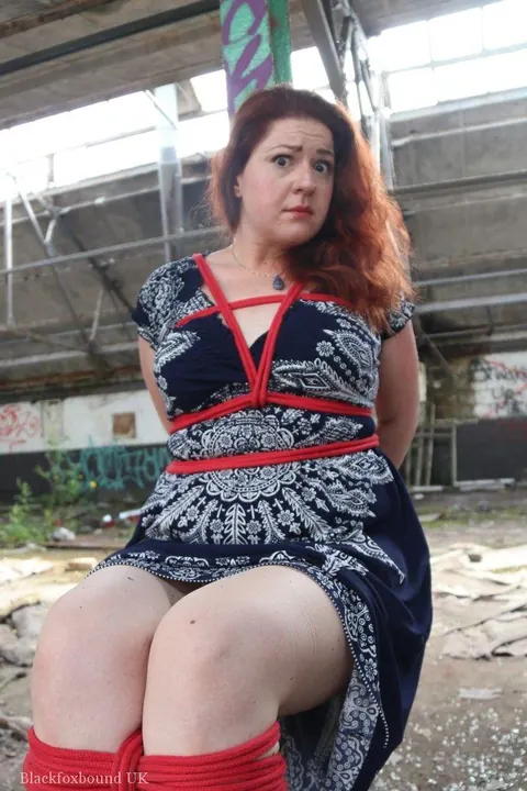 Curvy Redhead Bound and Gagged to a Post in a Warehouse – photo 10 of 16