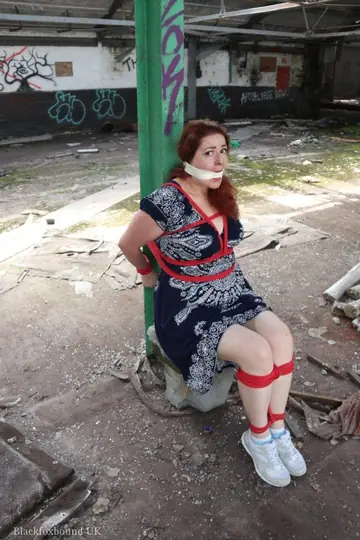 Curvy Redhead Bound and Gagged to a Post in a Warehouse