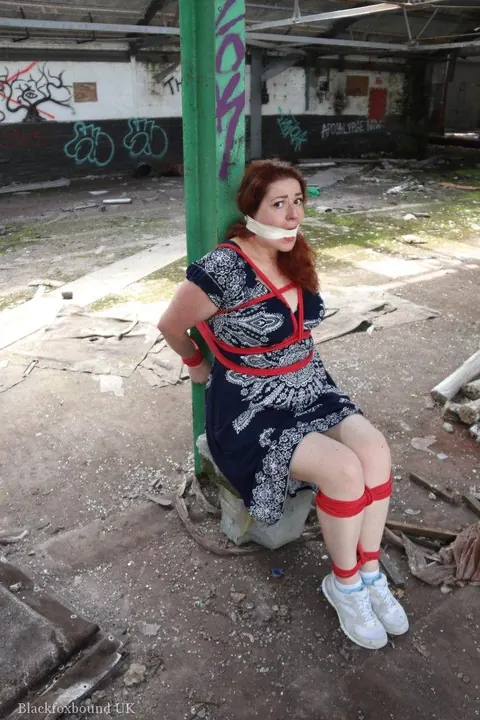 Curvy Redhead Bound and Gagged to a Post in a Warehouse – photo 1 of 16