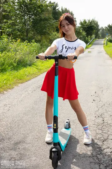 Woman Strips Out of Her Skirt in Socks and Sneakers Outdoors