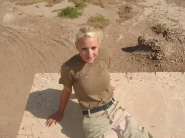 Blonde in a Military Uniform Strips Nude and Poses