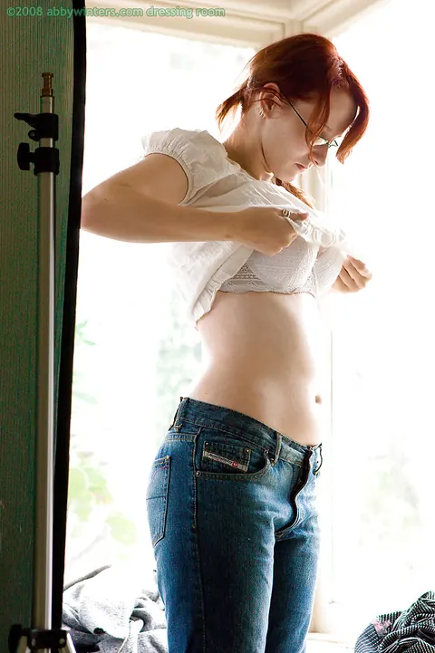 Thick Busty Redhead in Glasses Poses Nude Then Pulls on Panties and Jeans – photo 14 of 16