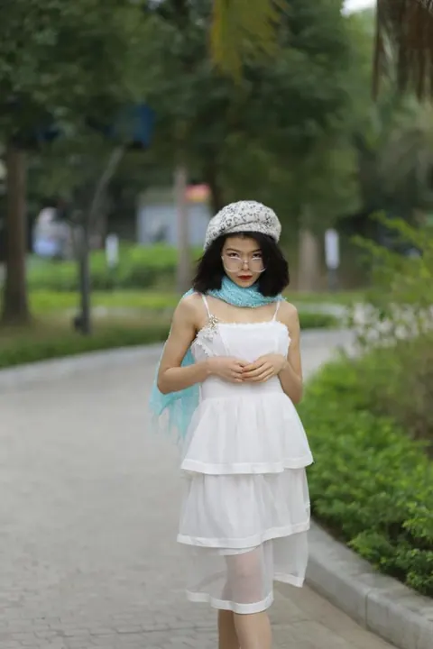 Asian Brunette Poses in a White Dress and Hat Outdoors – photo 3 of 21
