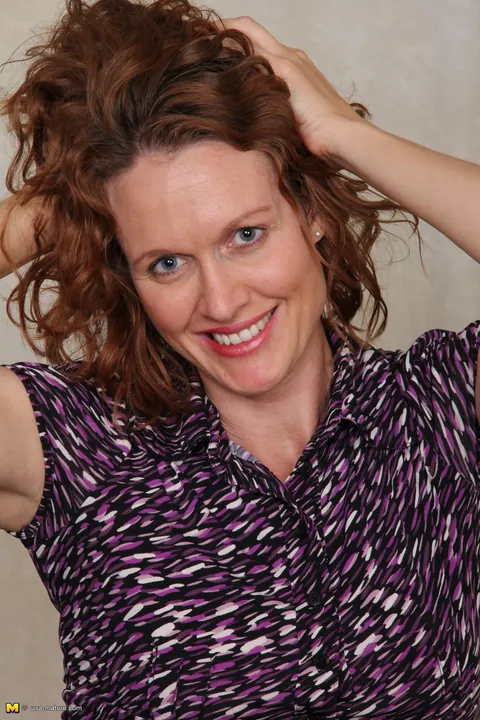 Roxanne Clemmens: Tall Redhead MILF Strips Out of Her Skirt in the Office – photo 4 of 16