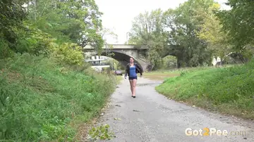 Tattooed Tall Brunette Pulls Down Her Shorts and Pees on Public Path