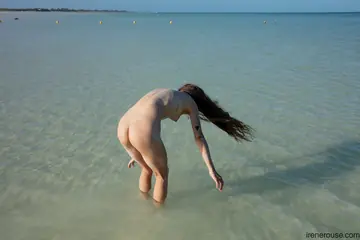 Slim Tattooed Latina Poses Nude on the Beach