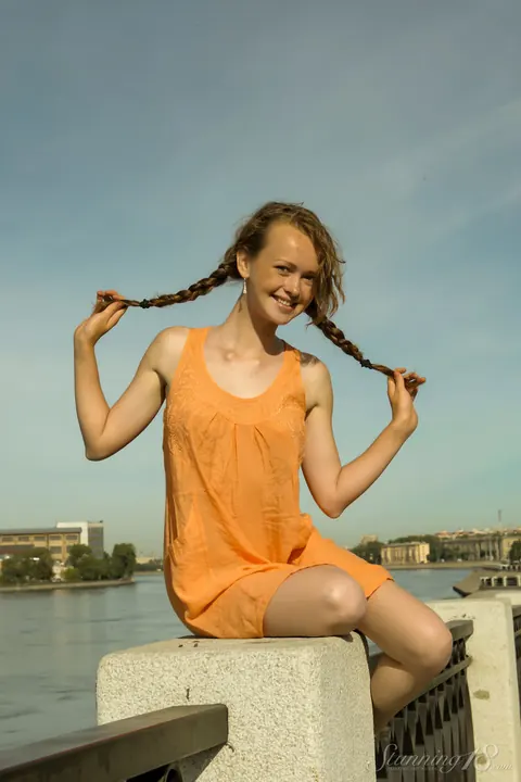 Brunette in a Skirt Spreads Her Pussy Outdoors by the Water – photo 4 of 16