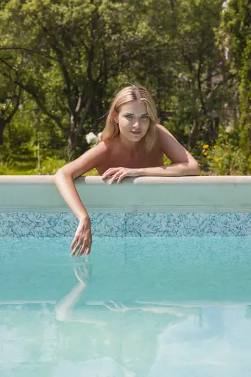 Woman in a Bikini Strips and Spreads at the Pool and in the Forest
