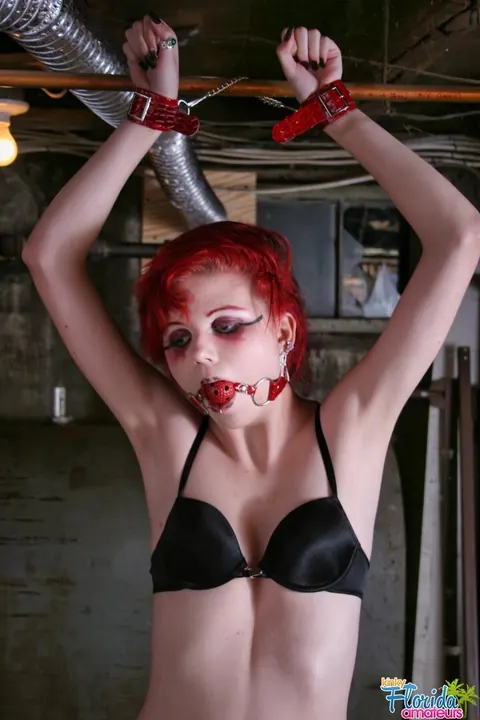 Redhead in Lingerie Spreads Her Pussy While Bound and Gagged in a Basement – photo 10 of 12