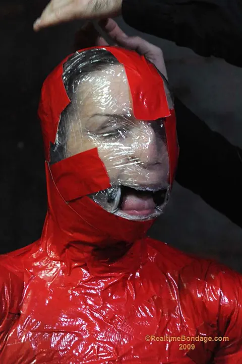 Claire Adams: Redhead MILF in Glasses Gets Wrapped Tight in Latex Mummification – photo 4 of 16