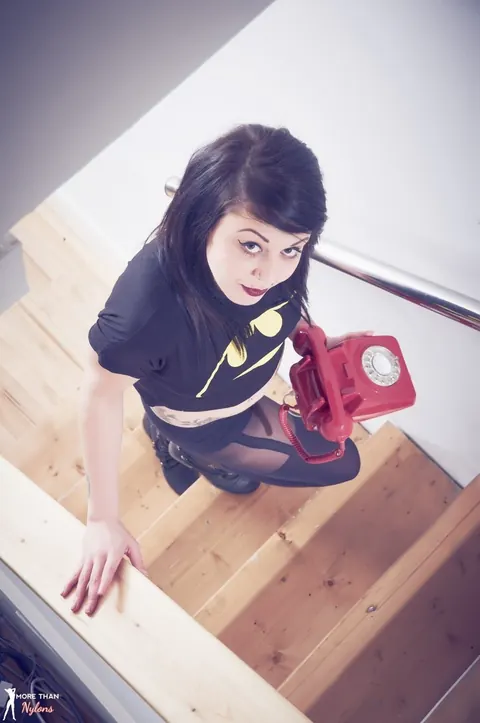 British Brunette in Pantyhose Answers a Retro Phone on the Stairs – photo 1 of 12