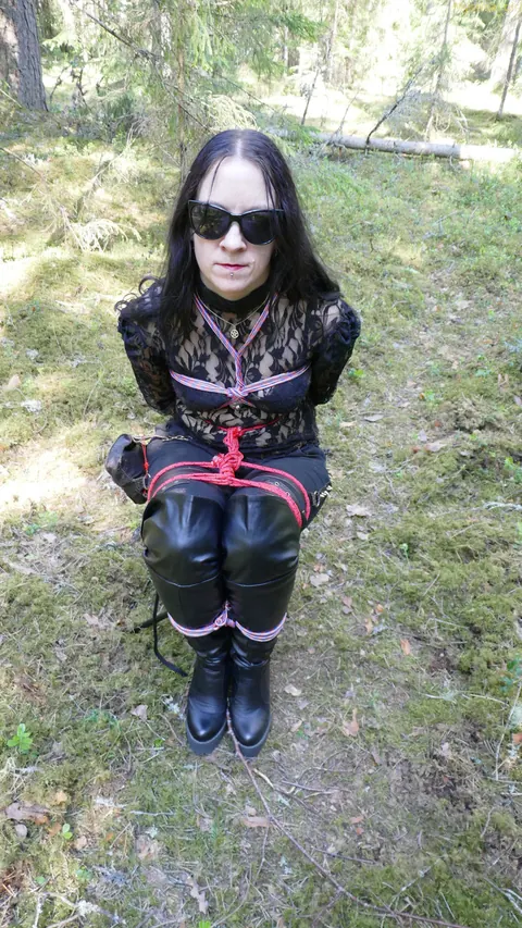 Brunette Bound to a Tree in Leather and Glasses Outdoors – photo 11 of 16