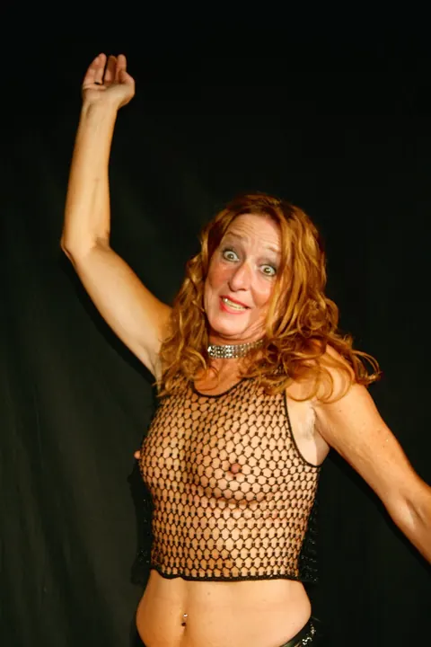 Kyra Nylons: Curly Redhead MILF Shows Her Big Tits in Fishnet Top – photo 15 of 15