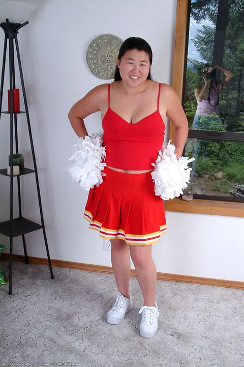 Chubby Asian Woman Sheds Her Cheer Uniform to Spread Her Hairy Pussy – photo 1 of 16