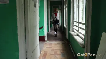 European Blonde in Uniform Poses by the Mirror Outdoors