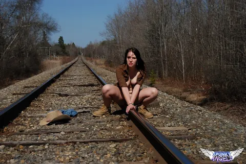 Emily Love: Amateur Brunette in Shorts and Boots Spreads on Railway Tracks – photo 7 of 12