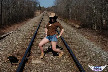Amateur Brunette in Shorts and Boots Spreads on Railway Tracks