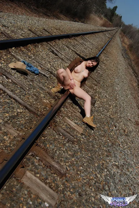 Emily Love: Amateur Brunette in Shorts and Boots Spreads on Railway Tracks – photo 8 of 12