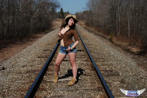 Emily Love: Amateur Brunette in Shorts and Boots Spreads on Railway Tracks – photo 2 of 12