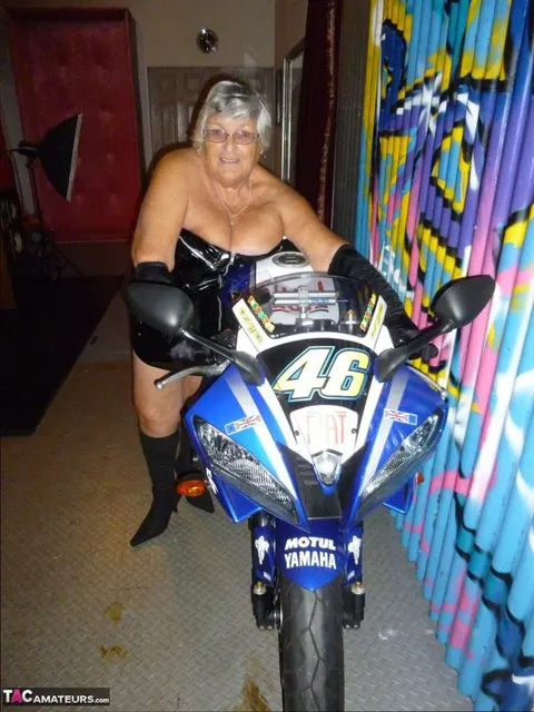 European Brunette with Big Tits Poses in Motorcycle Boots and Glasses – photo 3 of 20