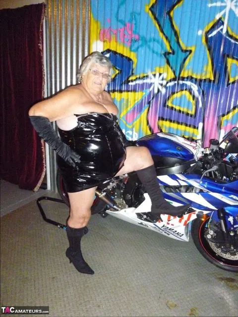 European Brunette with Big Tits Poses in Motorcycle Boots and Glasses – photo 2 of 20