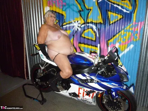 European Brunette with Big Tits Poses in Motorcycle Boots and Glasses – photo 18 of 20