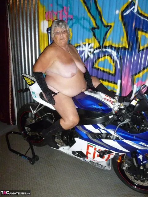 European Brunette with Big Tits Poses in Motorcycle Boots and Glasses – photo 17 of 20