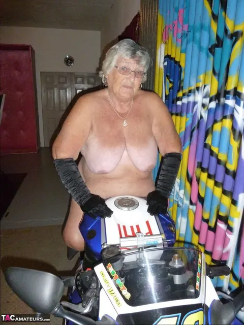 European Brunette with Big Tits Poses in Motorcycle Boots and Glasses – photo 14 of 20