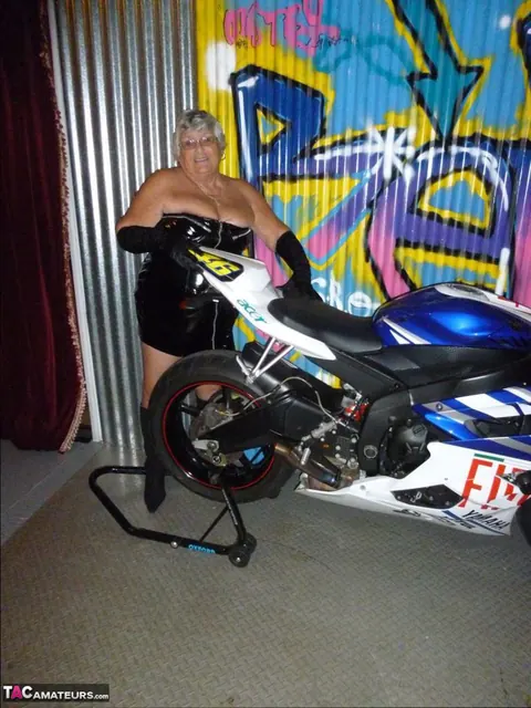 European Brunette with Big Tits Poses in Motorcycle Boots and Glasses – photo 4 of 20