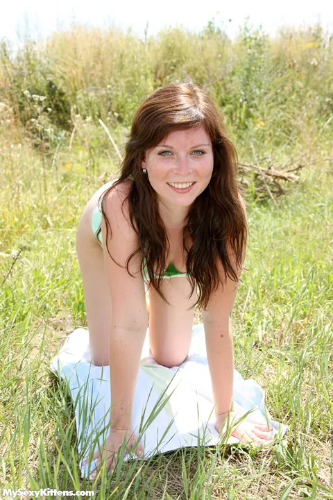 Redhead Masturbates with a Toy on the Grass by a Dirt Road – photo 2 of 16