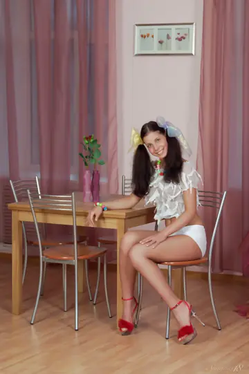 Woman in Pigtails, Shorts and High Heels Poses Playfully