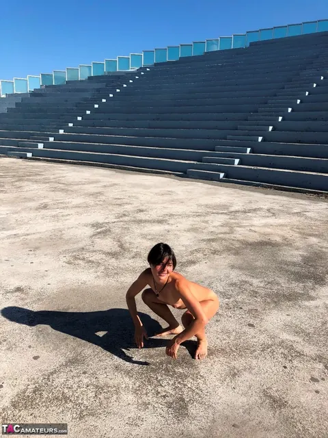 European Brunette Strips Out of Her Panties on a Concrete Stage – photo 12 of 16