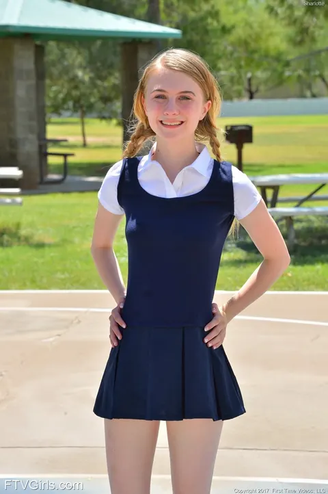 Charlotte Carmen: Skinny Blonde in Uniform Skirt Spreads Outdoors – photo 1 of 16