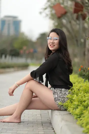 Petite Asian Woman Shows Her Feet in a Miniskirt and Shorts Outdoors