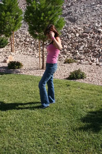 Brunette Amateur in Jeans Pulls Off Her Top Outdoors