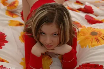 Woman Goes Topless in Red Panties on the Bed