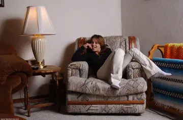 Hairy Woman in White Socks Spreads on a Chair