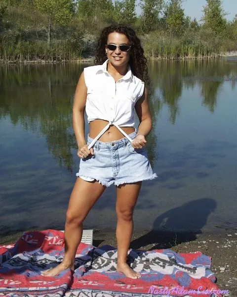 Woman in Shorts and Glasses Takes Two Men Outdoors – photo 1 of 15
